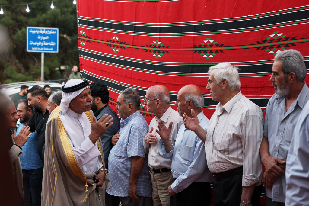 Residents gather to mourn former chess champion Rania al-Abbasi and her family, who disappeared 13 years ago, after relatives announced Monday they had evidence the family was killed by pro-government gunmen in 2013, in Damascus, Syria, Tuesday, June 2, 2026. (AP Photo/Ghaith Alsayed)