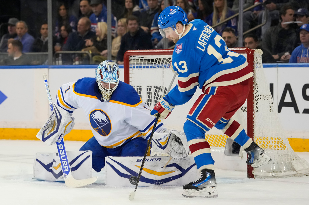 New York Rangers left wing Alexis Lafrenière (13) shoots the puck during the period of an NHL hockey game against Buffalo Sabres, Wednesday, April 8, 2026, in New York. (AP Photo/Yuki Iwamura)
