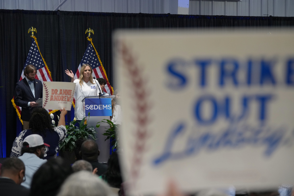 Dr. Annie Andrews, a Democrat running against Sen. Lindsey Graham, R-S.C., waves from the stage at the South Carolina Democratic Party Convention, Saturday, May 30, 2026, in Columbia, S.C. (AP Photo/Meg Kinnard)