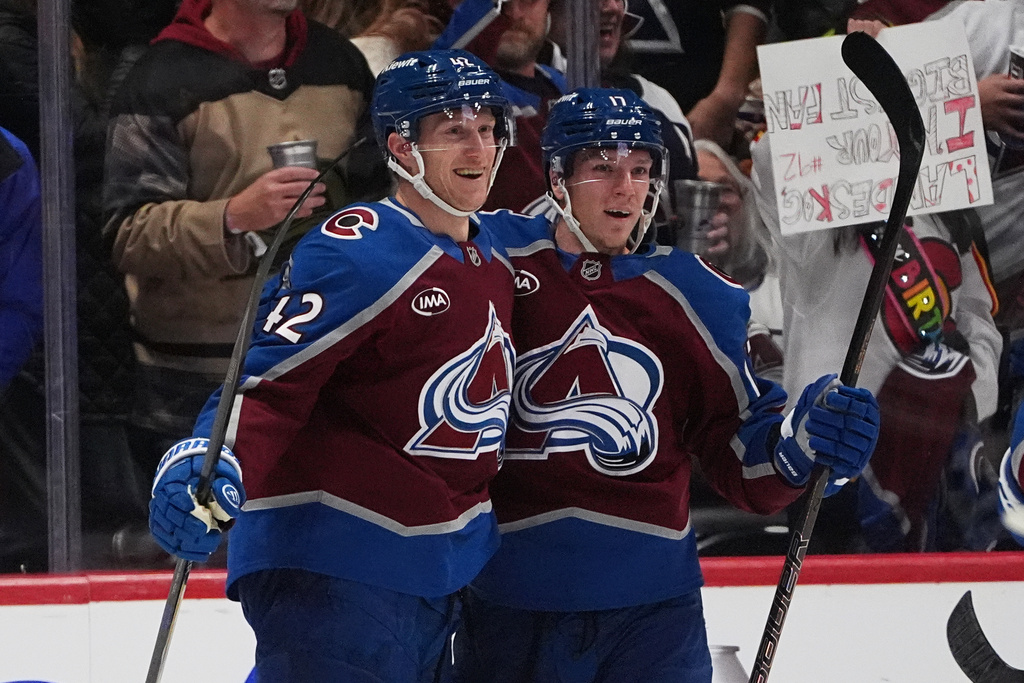 Colorado Avalanche defenseman Josh Manson, left, is congratulated by center Parker Kelly after scoring a goal against the San Jose Sharks in the second period of an NHL hockey game Wednesday, Nov. 26, 2025, in Denver. (AP Photo/David Zalubowski)