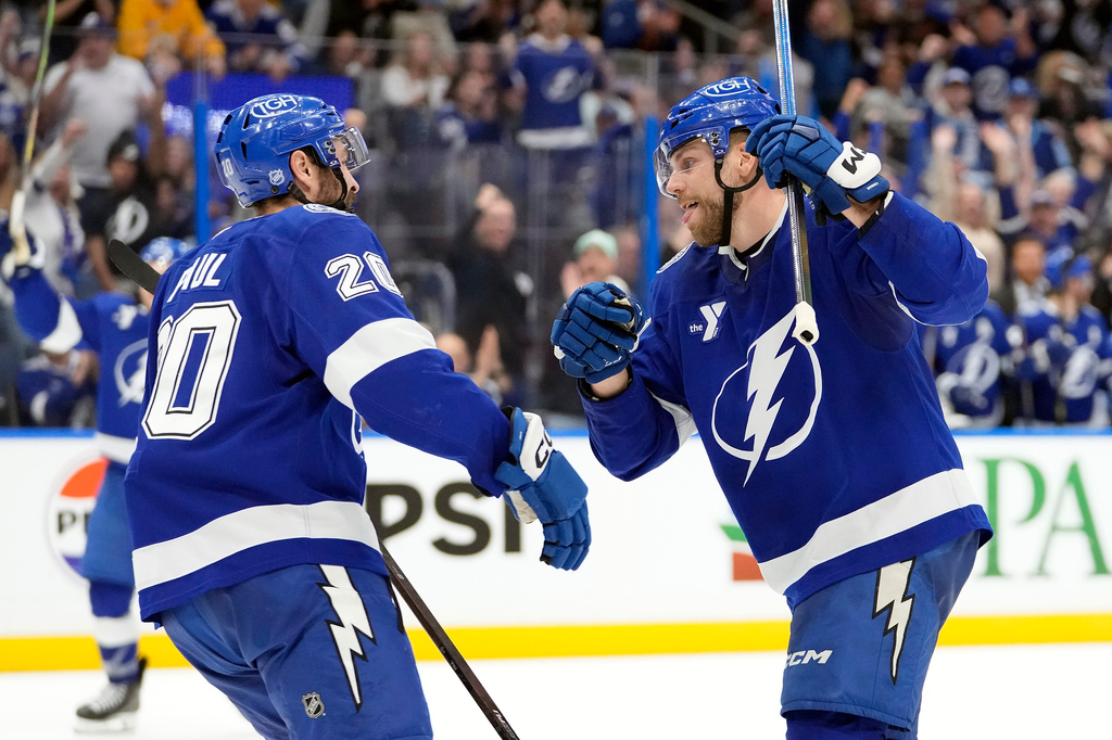 Tampa Bay Lightning defenseman Erik Cernak (81) celebrates his goal against the Detroit Red Wings with left wing Nick Paul (20) during the second period of an NHL hockey game Monday, April 13, 2026, in Tampa, Fla. (AP Photo/Chris O'Meara)