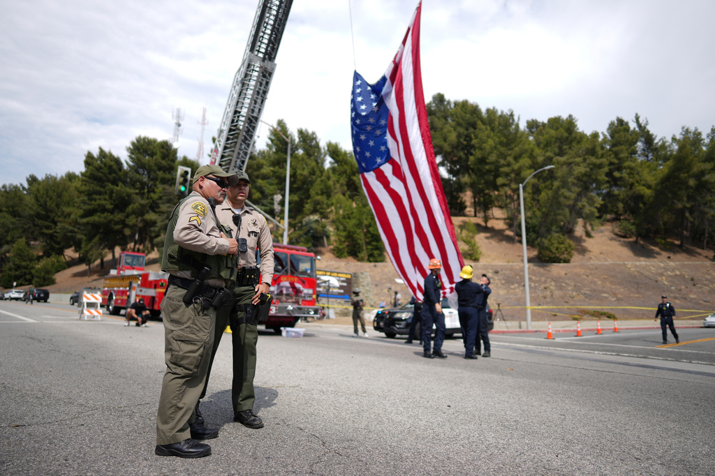 FILE - Sheriff's deputies stand along a procession route near where an explosion at a training facility killed three deputies July 18, 2025, in Los Angeles. (AP Photo/Eric Thayer, File)