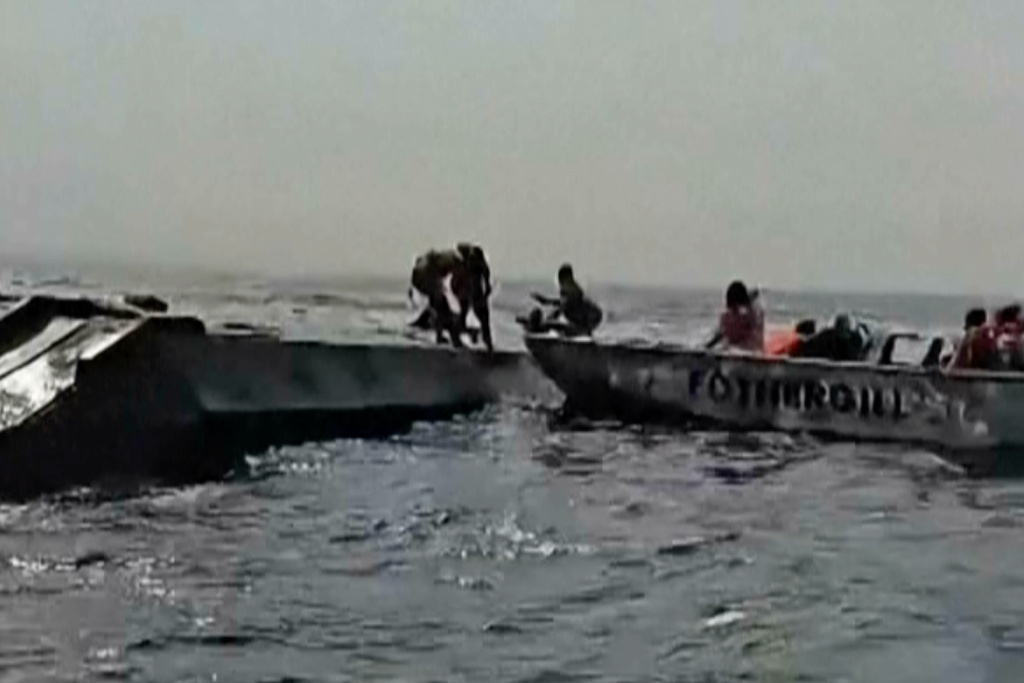 In this image taken from a video people are rescued from an overloaded ferry that capsized on Zimbabwe's Lake Kariba on Tuesday, Aug. 11, 2026. (Maxton Kanhema via AP)