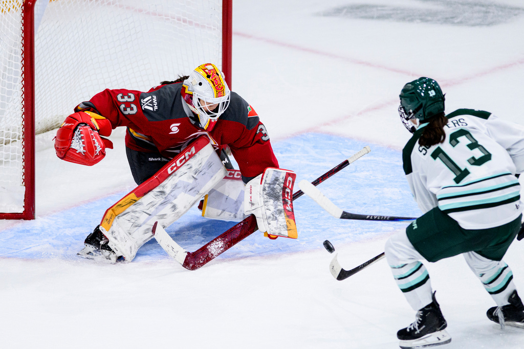 Ottawa Charge goaltender Gwyneth Philips (33) tracks the puck from a shot by Boston Fleet's Lix Schepers (13) during overtime in a PWHL hockey game in Ottawa, Ontario, on Saturday, Dec. 27, 2025. (Spencer Colby/The Canadian Press via AP)