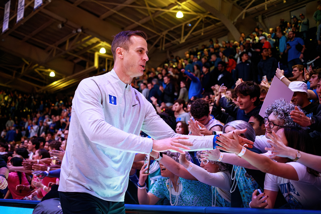 Duke head coach Jon Scheyer greets fans after his team defeated Syracuse in an NCAA college basketball game in Durham, N.C., Monday, Feb. 16, 2026. (AP Photo/Ben McKeown)