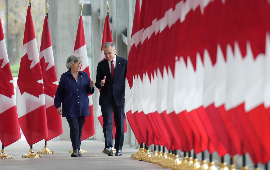 Canada Prime Minister Mark Carney walks with Louise Arbour to announce the new governor general during an event in Ottawa, Tuesday, May 5 2026. (Adrian Wyld/The Canadian Press via AP)