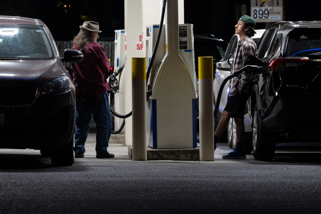 People fill up fuel tanks at a gas station on Wednesday, May 6, 2026, in Portland, Ore. (AP Photo/Jenny Kane)