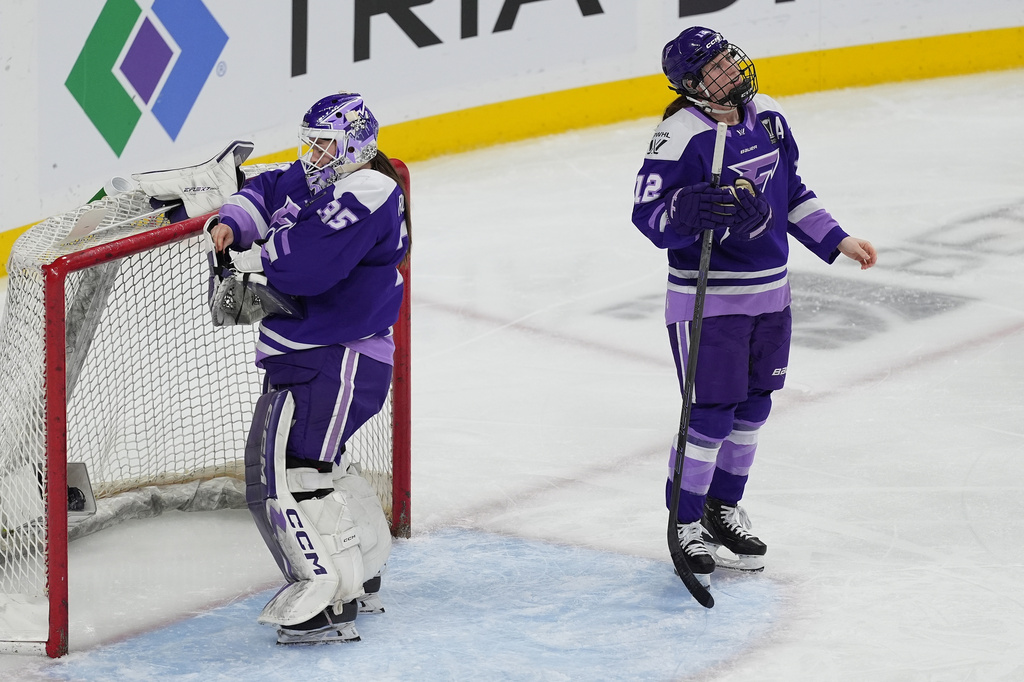 Minnesota Frost goaltender Maddie Rooney (35) and forward Kelly Pannek (12) wait for play to resume after a goal scored by Montreal Victoire defenseman Maggie Flaherty (91) during the second period of game 3 of a PWHL hockey semifinals game Thursday, May 7, 2026, in St. Paul, Minn. (AP Photo/Abbie Parr)