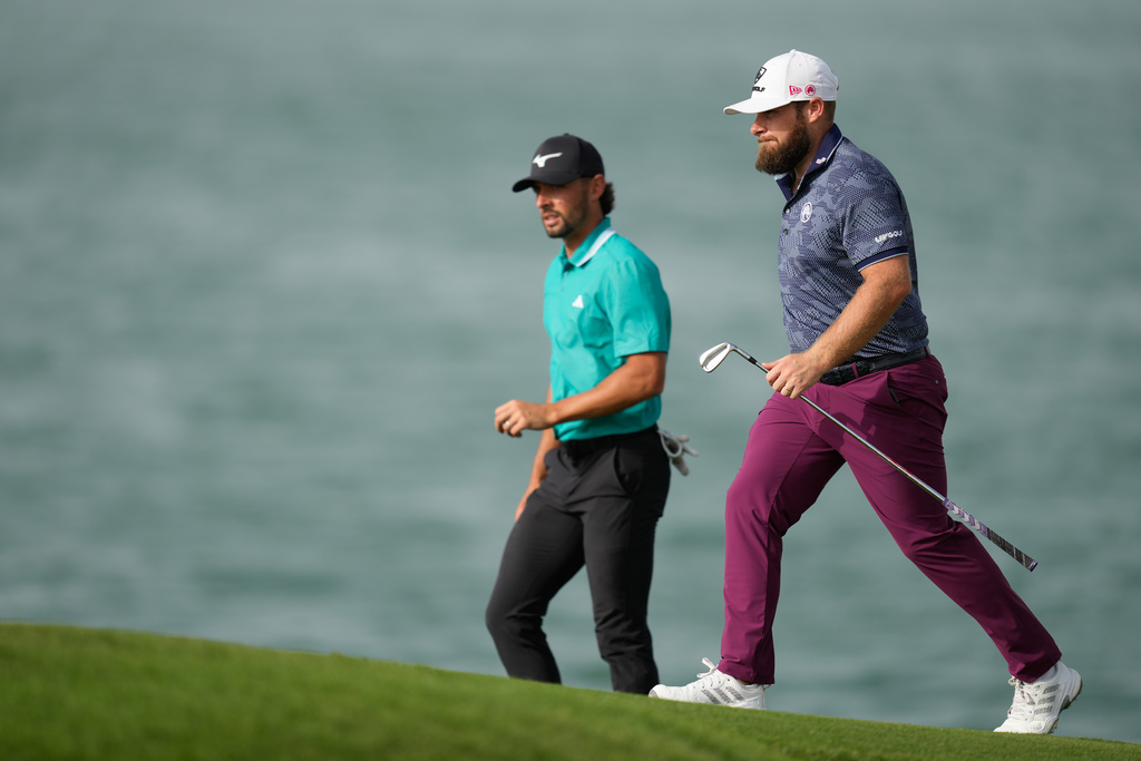 Marco Penge of England, left, and Tyrell Hatton of England walk towards 16th fairway during the second round of Abu Dhabi Golf Championship in Abu Dhabi, United Arab Emirates, Friday, Nov. 7, 2025. (AP Photo/Altaf Qadri)