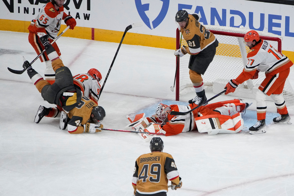Anaheim Ducks goaltender Lukas Dostal (1) covers the puck against the Vegas Golden Knights during the first period of Game 1 of a second-round NHL hockey Stanley Cup playoff series Monday, May 4, 2026, in Las Vegas. (AP Photo/John Locher)