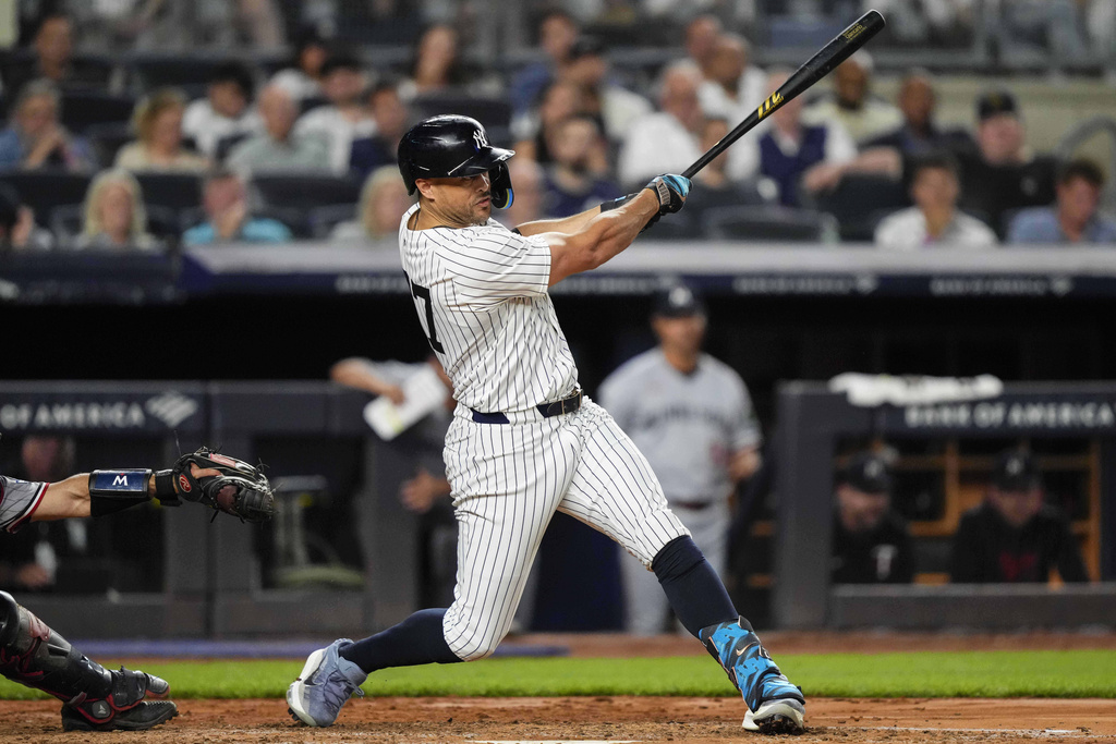 New York Yankees' Giancarlo Stanton (27) hits a home run during the fifth inning of a baseball game against the Minnesota Twins, Tuesday, Aug. 12, 2025, in New York. (AP Photo/Yuki Iwamura)