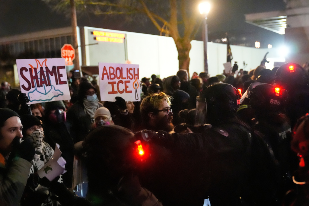 Protesters standoff against law enforcement outside the U.S. Immigration and Customs Enforcement facility on Thursday, Jan. 8, 2026, in Portland, Ore. (AP Photo/Jenny Kane)
