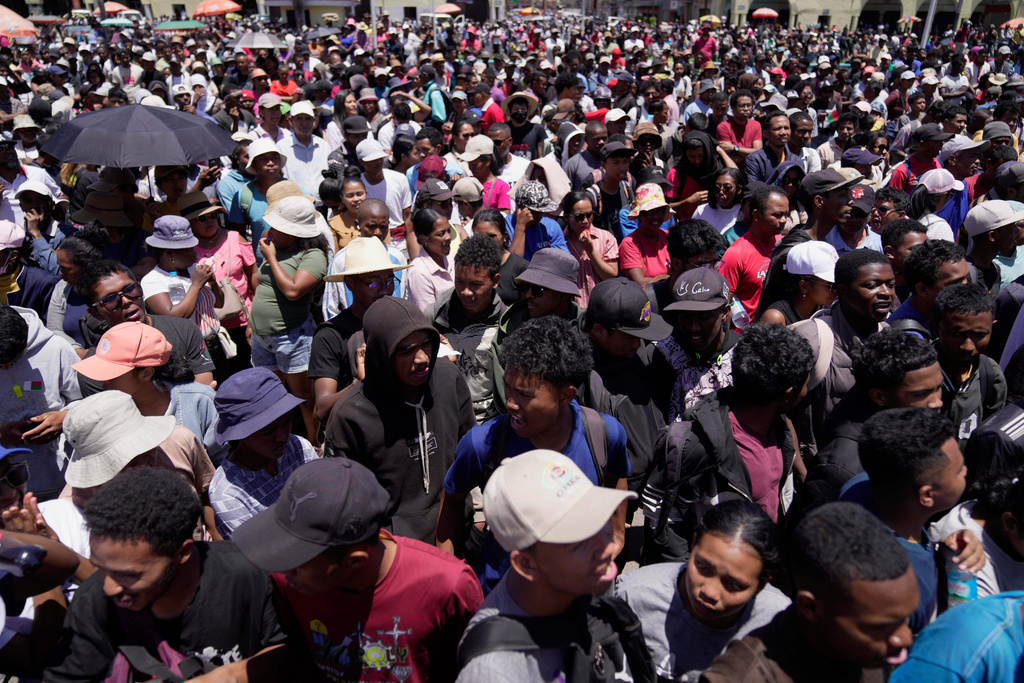Protesters listen to speeches during a protest calling for President Andry Rajoelina to step down in Antananarivo, Madagascar, Tuesday, Oct. 14, 2025. (AP Photo/Brian Inganga)