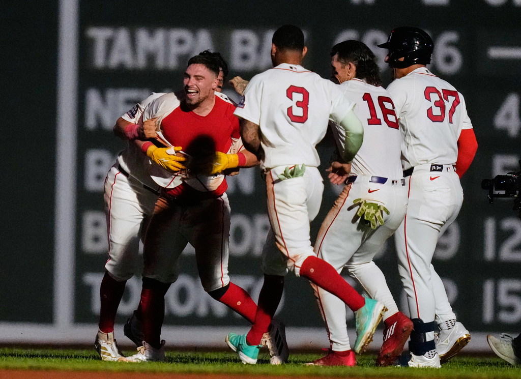 Boston Red Sox's Caleb Durbin, left, celebrates with teammates after his game-winning RBI single during the 13th inning of a baseball game against the Chicago White Sox, Thursday, Aug. 6, 2026, in Boston. (AP Photo/Charles Krupa)