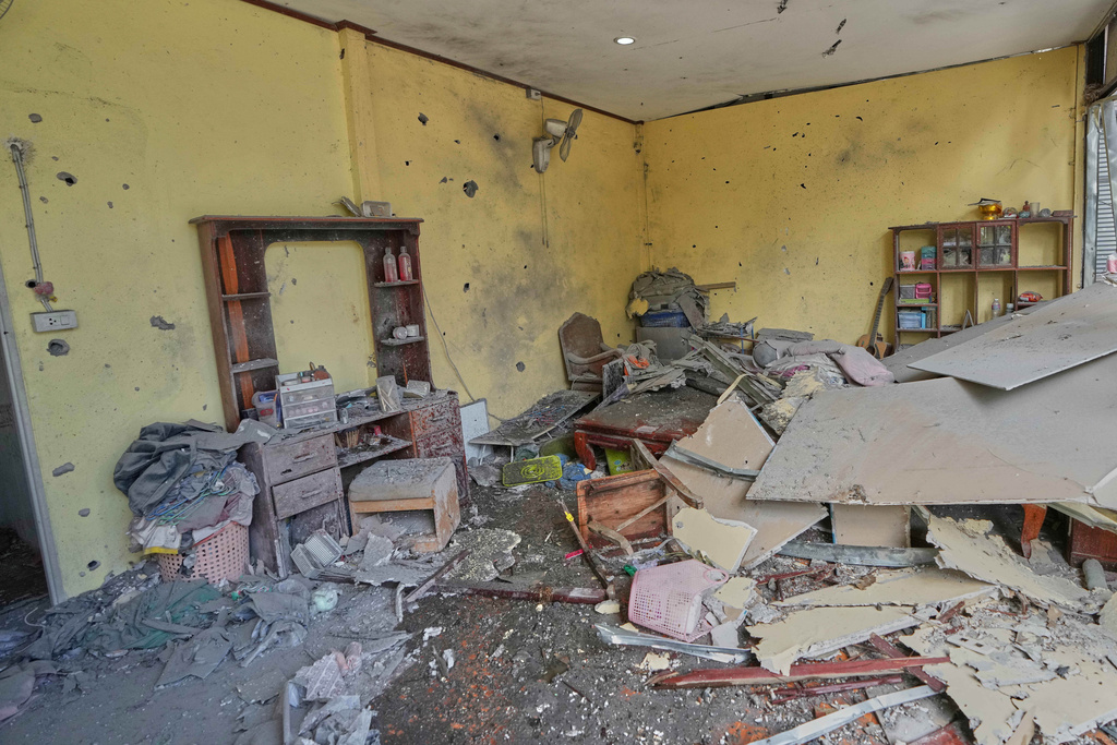 This shows a house which, Thai local security forces say, was damaged by a Cambodian artillery strike in Surin province, Thailand, Thursday, Dec. 11, 2025. (AP Photo/Sakchai Lalit)