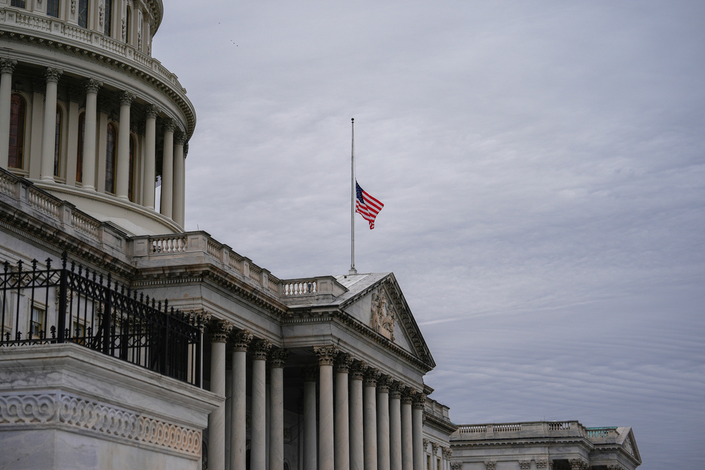 The American flag flies half-staff outside the U.S. Capitol, Tuesday, Nov. 18, 2025, in Washington. (AP Photo/Julia Demaree Nikhinson)