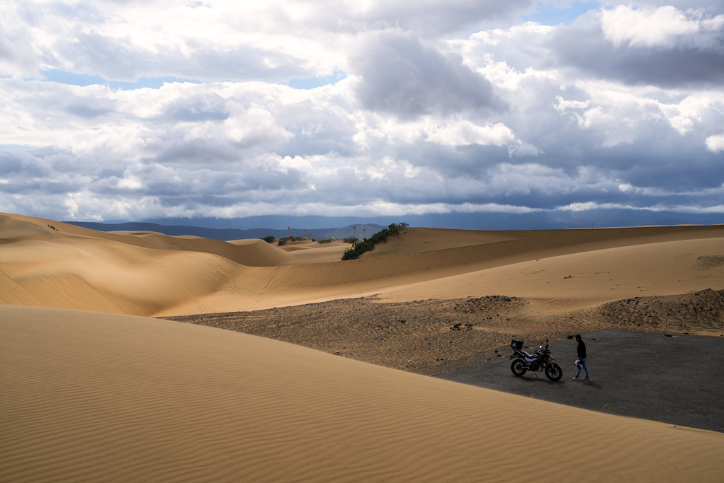 A motorcyclist looks out over Medanos de Coro National Park in Falcon state, Venezuela, Wednesday, Jan. 14, 2026. (AP Photo/Matias Delacroix)