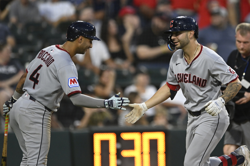 Cleveland Guardians' C.J. Kayfus, right, celebrates with teammate Brayan Rocchio, after hitting a solo home run during the sixth inning of a baseball game against the Chicago White Sox, Saturday, Aug. 9, 2025, in Chicago. (AP Photo/Paul Beaty)