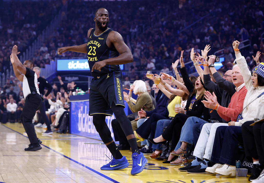 Golden State Warriors forward Draymond Green (23) reacts after scoring a three point basket against the Indiana Pacers during the first half of an NBA basketball game Sunday, Nov. 9, 2025, in San Francisco. (AP Photo/Kelley L Cox)