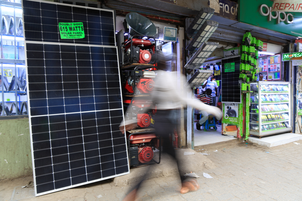 A man walks past solar panels displayed for sale in Nairobi, Kenya, Thursday, July 16, 2026. (AP Photo/Andrew Kasuku) CORRECTION: Corrects day to Thursday instead of Tuesday.