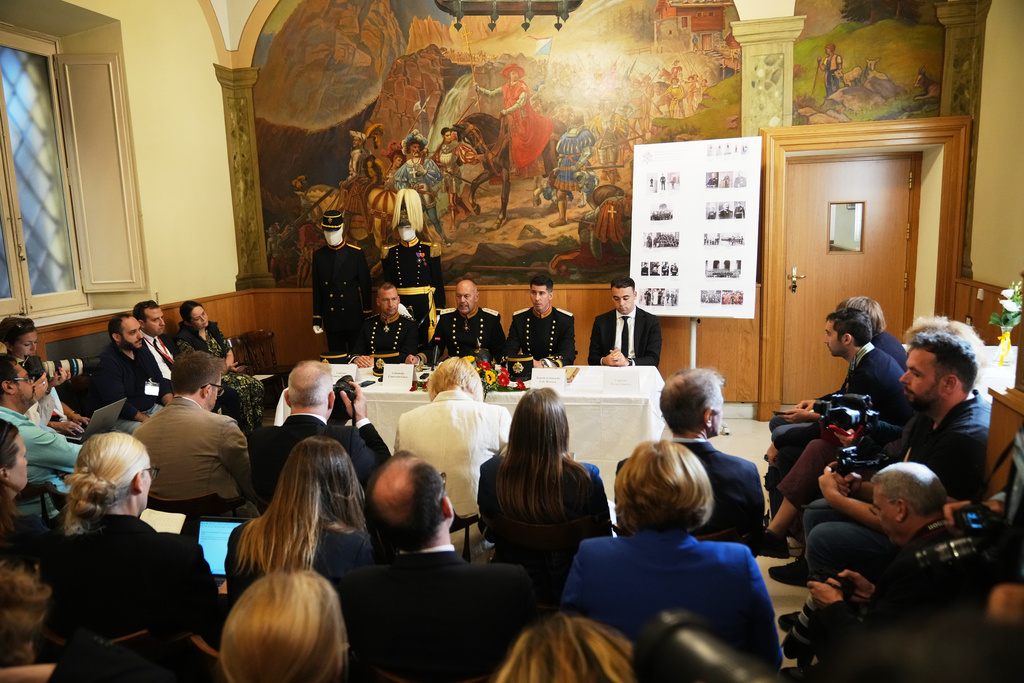 From left, Captain Lorenz Keusch, Colonel Christoph Graf, Lieutenant Colonel Loic Marc Rossier, and Vice-Corporal Eliah Cinotti attend a press conference on the occasion of the presentation of the Swiss Guard Mezza-Gala uniform in the Swiss Guard Barracks at the Vatican, Thursday, Oct. 2, 2025. (AP Photo/Alessandra Tarantino)
