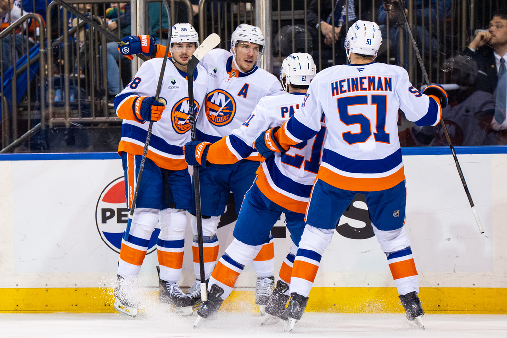 New York Islanders players celebrate a goal against the New York Rangers during the first period of an NHL hockey game, Saturday, Nov. 8, 2025, in New York. (AP Photo/Angelina Katsanis)
