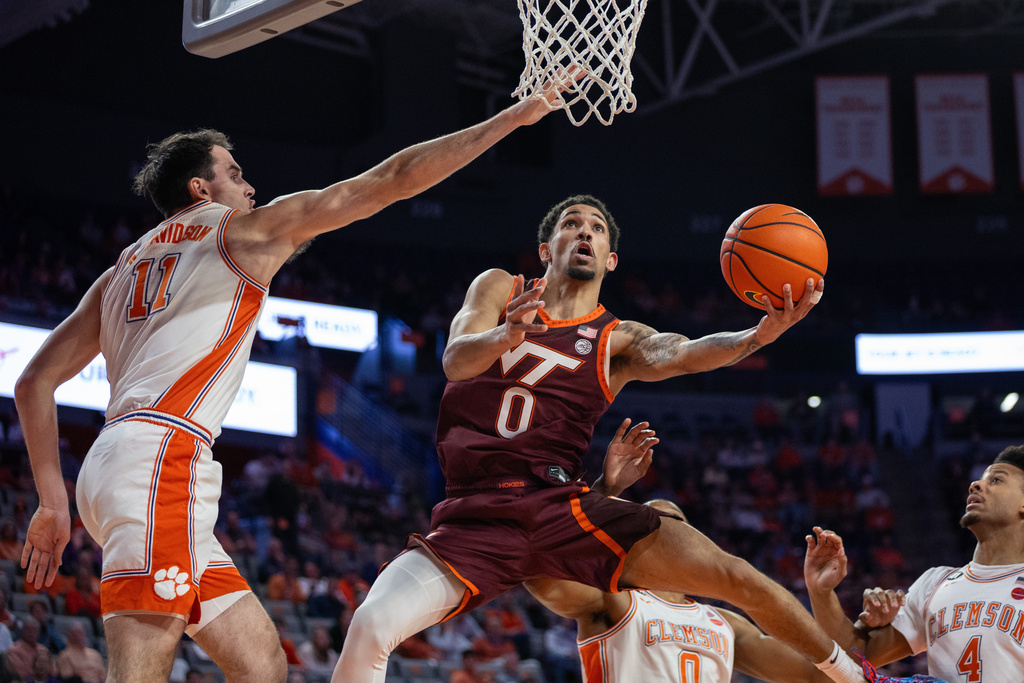 Virginia Tech guard Jailen Bedford (0) shoots against Clemson forward Nick Davidson (11) during the first half of an NCAA college basketball game Wednesday, Feb. 11, 2026, in Clemson, S.C. (AP Photo/Scott Kinser)