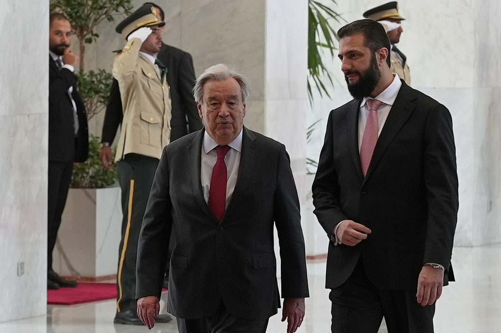 Syrian President Ahmad al-Sharaa, right, walks with United Nations Secretary General Antonio Guterres, at the Syrian presidential palace in Damascus, Syria, Saturday, July 25, 2026. (AP Photo/Omar Albam)