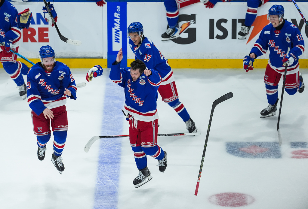 Kitchener Rangers' Dylan Edwards, front center, Luke Ellinas, left, Tanner Lam, back center, and Cameron Arquette, right, celebrate after Kitchener defeated the Everett Silvertips to win the Memorial Cup final hockey game in Kelowna, British Columbia, on Sunday, May 31, 2026. (Darryl Dyck/The Canadian Press via AP)
