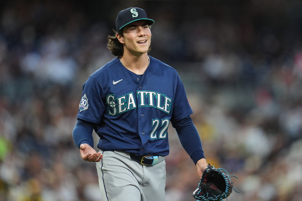Seattle Mariners starting pitcher Bryan Woo reacts towards first base umpire Bill Miller after being called for a balk during the second inning of a baseball game against the San Diego Padres Tuesday, April 14, 2026, in San Diego. (AP Photo/Gregory Bull)