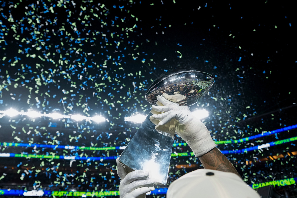 FILE - A member of the Seattle Seahawks celebrates with the Lombardi Trophy after defeating the New England Patriots in the NFL Super Bowl 60 football game, Feb. 8, 2026, in Santa Clara, Calif. (AP Photo/Brynn Anderson, File)