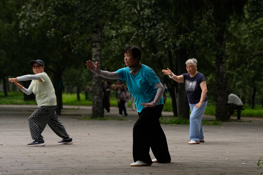 Women practice Tai Chi at a park near the Temple of Heaven in Beijing, Thursday July 9, 2026. (AP Photo/Andy Wong)