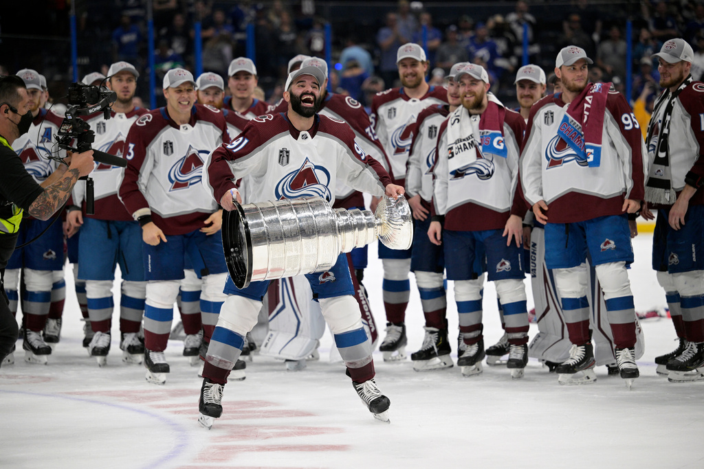 FILE - Colorado Avalanche center Nazem Kadri (91) lifts the Stanley Cup after the team defeated the Tampa Bay Lightning in Game 6 of the NHL hockey Stanley Cup Finals, June 26, 2022, in Tampa, Fla. (AP Photo/Phelan M. Ebenhack, File)