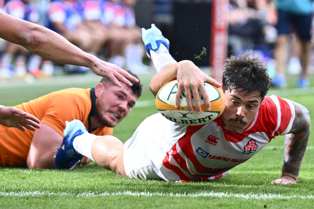 Dylan Riley, right, of Japan reaches out to score a try during a rugby international between Japan and Australia in Townsville, Australia, Saturday, Aug.15, 2026. (Matt Taylor/AAPImage via AP)