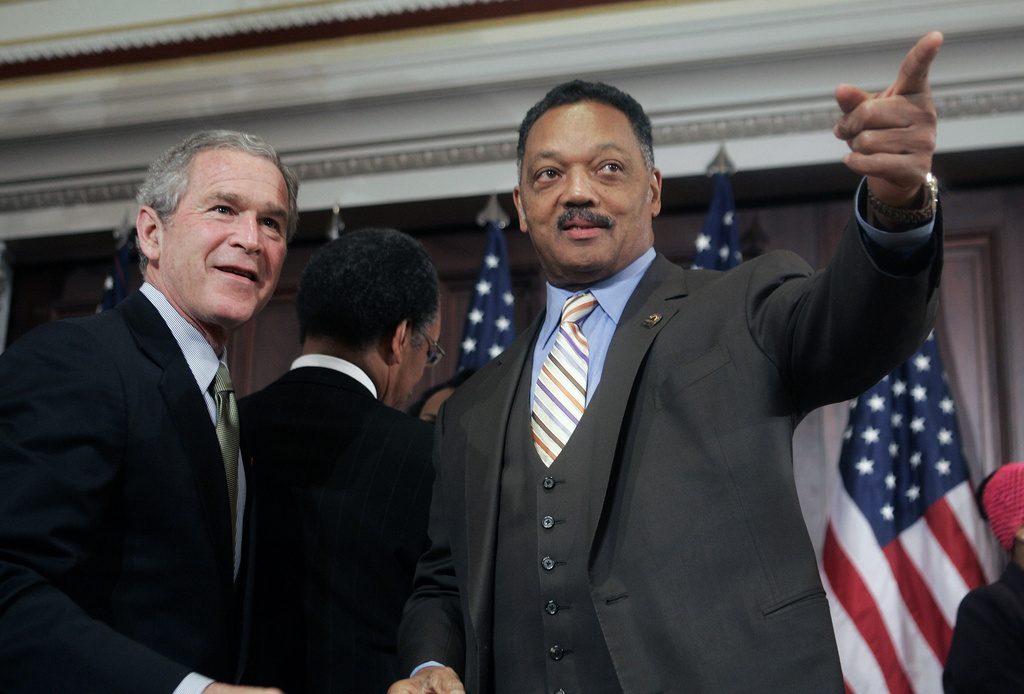 FILE - President George W. Bush speaks with Rev. Jesse Jackson, right, after signing a bill in the Eisenhower Executive Office Building, Dec. 1, 2005, authorizing a statue of civil rights leader Rosa Parks be placed in the U.S. Capitol's Statuary Hall. (AP Photo/Ron Edmonds, File)