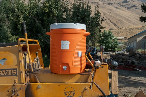 A water jug for farmworkers sits at an orchard in Naches, Wash., Thursday, Aug. 28, 2025. (AP Photo/Annika Hammerschlag) A water jug for farmworkers sits at an orchard in Naches, Wash., Thursday, Aug. 28, 2025. (AP Photo/Annika Hammerschlag)