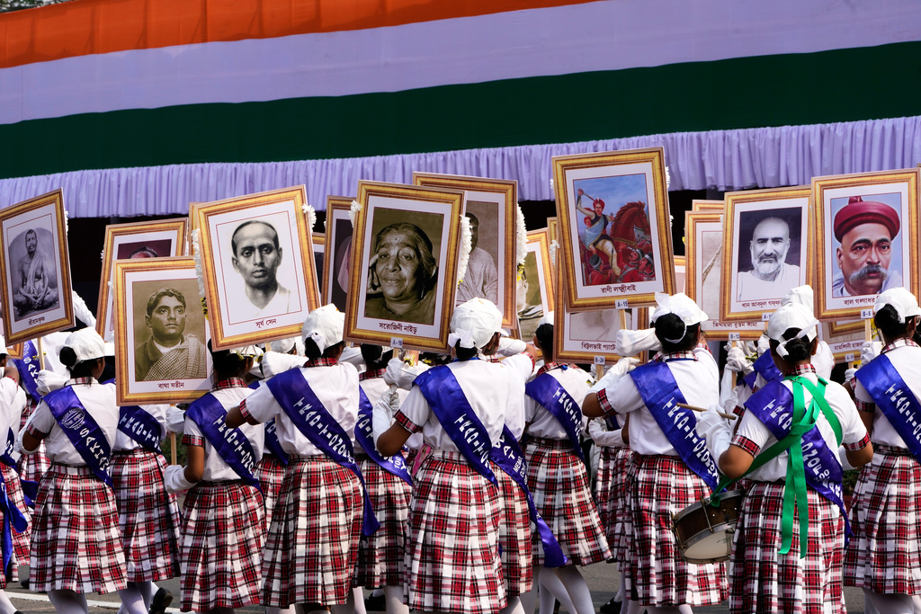 Schoolgirls walk with portraits of Indian freedom fighters and eminent personalities during a Republic Day ceremonial parade, in Kolkata, India, Monday, Jan. 26, 2026. (AP Photo/Bikas Das)