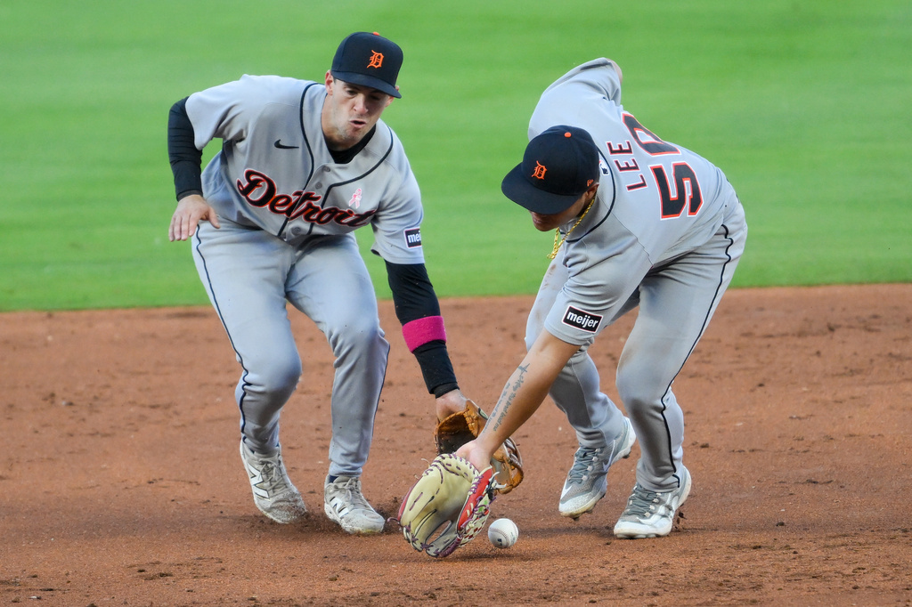 Detroit Tigers second baseman Hao-Yu Lee (50) and shortstop Zach Short, left, cannot make a play on a single hit by Kansas City Royals' Bobby Witt Jr. during the third inning of a baseball game in Kansas City, Mo., Sunday, May 10, 2026. (AP Photo/Reed Hoffmann)