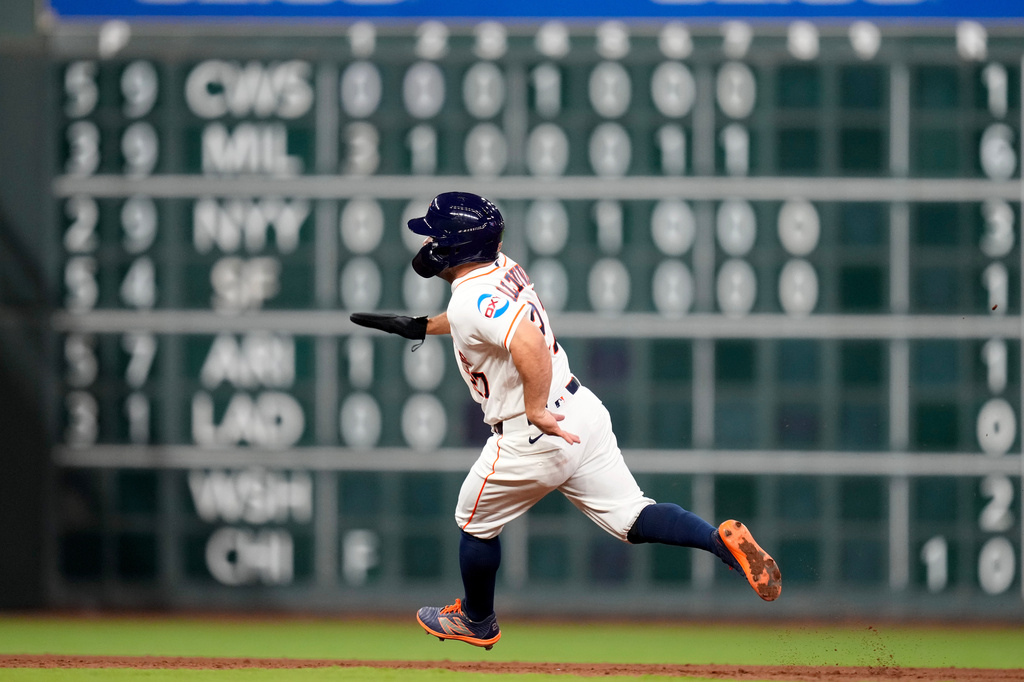 Houston Astros' Jose Altuve runs to third after Yordan Alvarez hit a single against the Los Angeles Angels during the seventh inning of a baseball game Saturday, March 28, 2026, in Houston. (AP Photo/Eric Christian Smith)