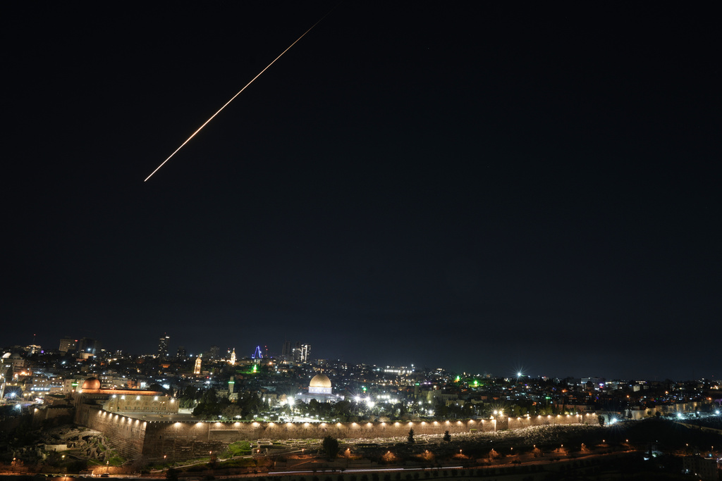 Trace of an air defense missile interception during an Iranian attack is seen over Jerusalem's Old City, Sunday, March 1, 2026. (AP Photo/Mahmoud Illean)