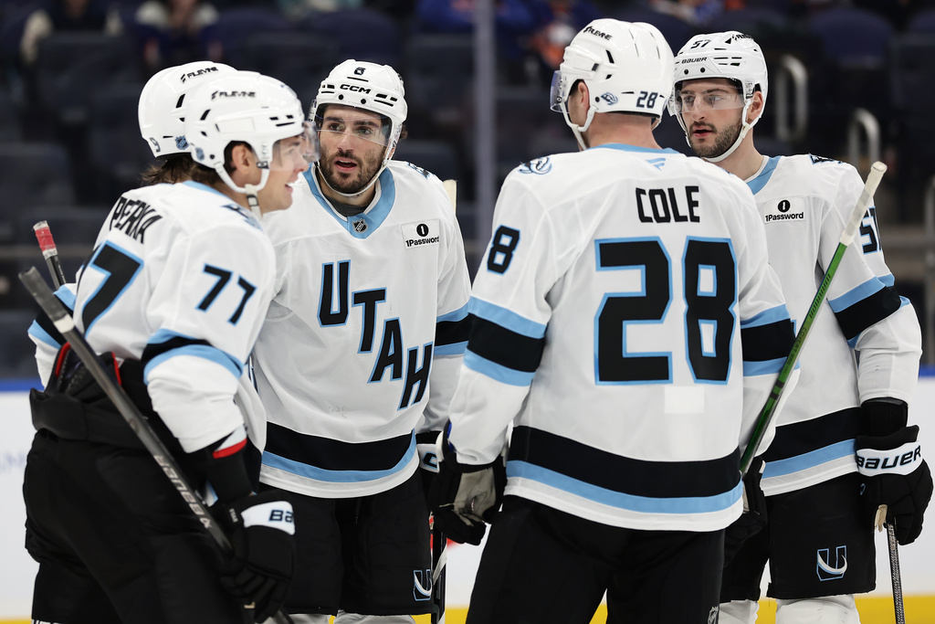 Utah Mammoth center Nick Schmaltz (8) celebrates with teammates after scoring his second goal of the game in the third period of an NHL hockey game against the Utah Mammoth, Thursday, Jan. 1, 2026, in Elmont, N.Y. (AP Photo/Adam Hunger)