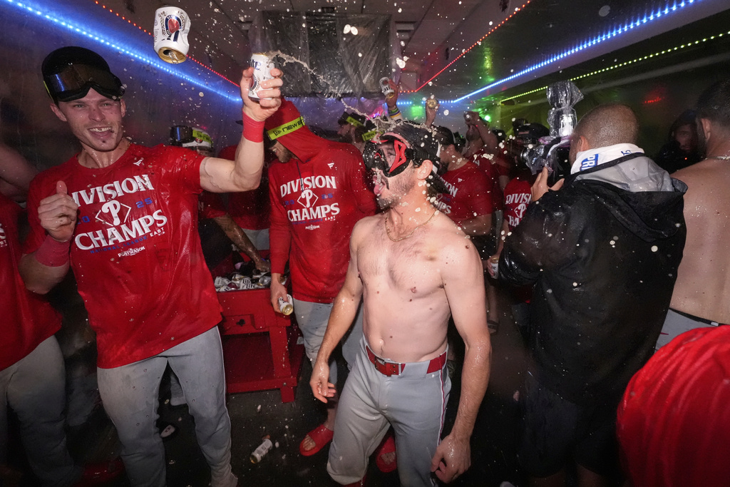 Members of the Philadelphia Phillies celebrate after they clinched the NL East following their defeat of the Los Angeles Dodgers in a baseball game Monday, Sept. 15, 2025, in Los Angeles. (AP Photo/Mark J. Terrill)