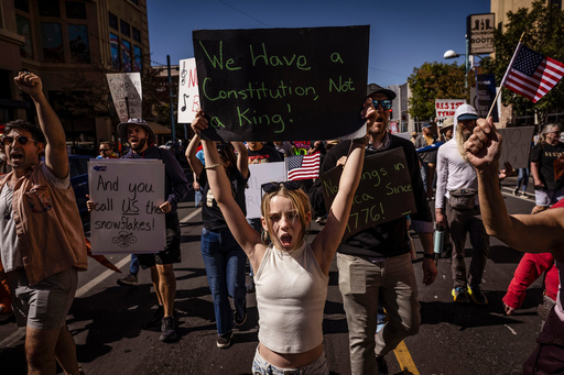 Daniella Diener participates with other protesters in the "No Kings" rally and march in downtown Albuquerque, N.M., on Saturday, Oct. 18, 2025. (Chancey Bush/The Albuquerque Journal via AP) Daniella Diener participates with other protesters in the "No Kings" rally and march in downtown Albuquerque, N.M., on Saturday, Oct. 18, 2025. (Chancey Bush/The Albuquerque Journal via AP)