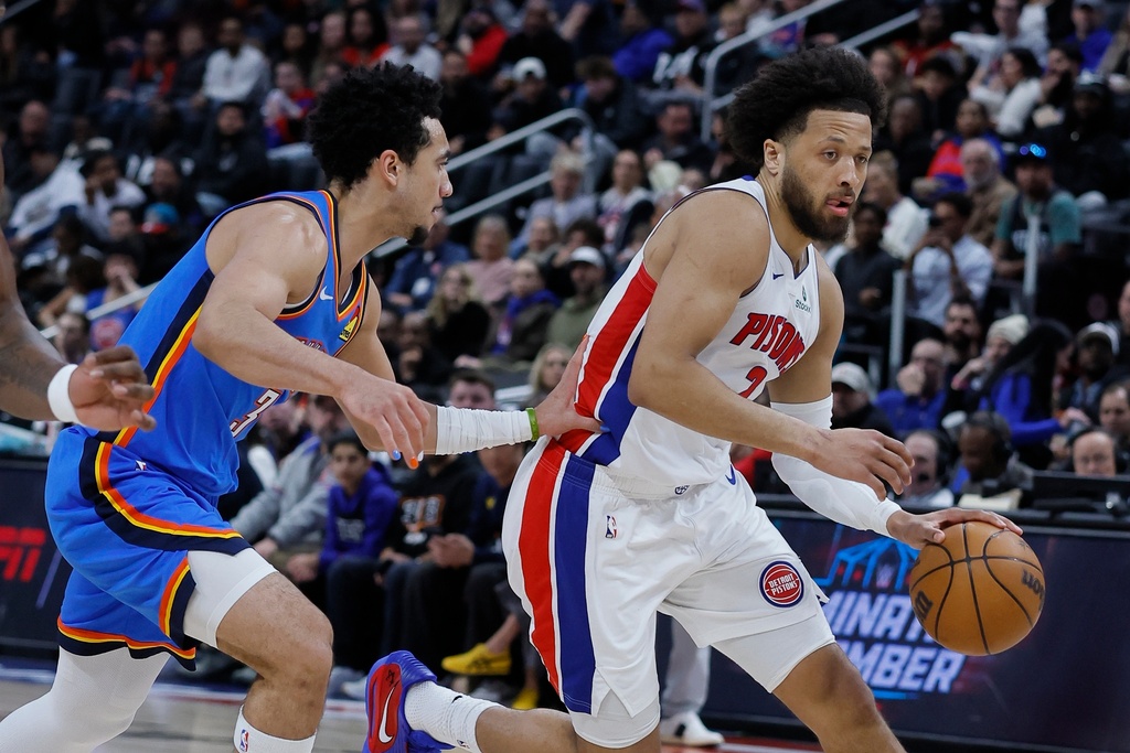 Detroit Pistons guard Cade Cunningham drives to the basket against Oklahoma City Thunder guard Jared McCain during the first half of an NBA basketball game, Wednesday, Feb. 25, 2026, in Detroit. (AP Photo/Duane Burleson)