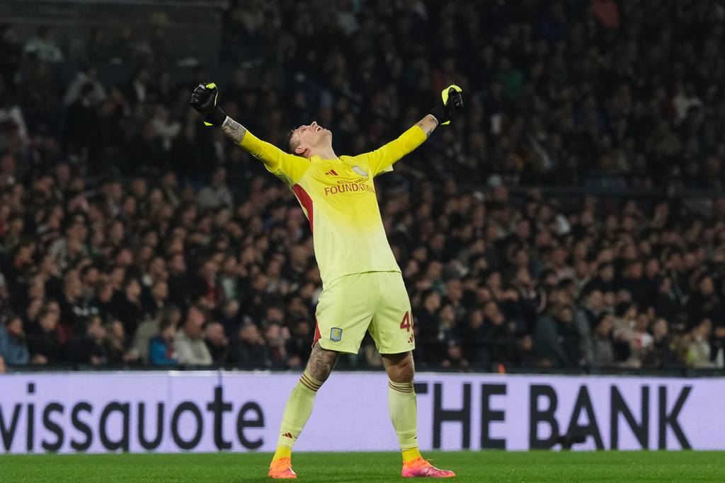 Aston Villa's goalkeeper Marco Bizot celebrates his side's opening goal scored by Emiliano Buendia during the Europa League opening phase soccer match between Feyenoord and Aston Villa at the Feyenoord "De Kuip" stadium in Rotterdam, Netherlands, Thursday, Oct. 2, 2025. (AP Photo/Patrick Post)