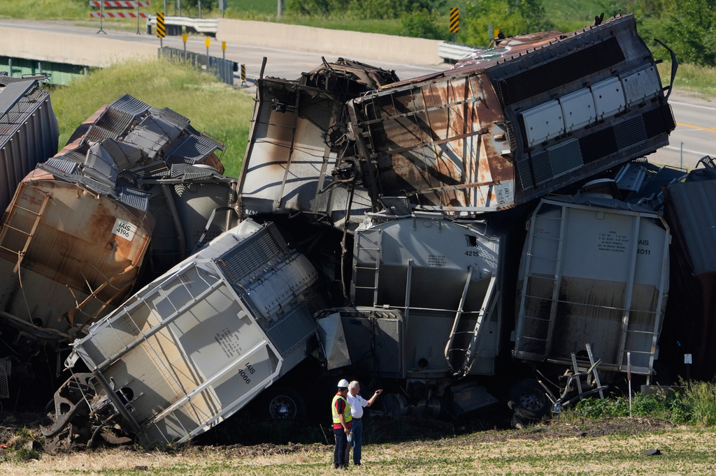 Workers respond after a train derailed on Wednesday, June 3, 2026, near Victor, Iowa. (AP Photo/Charlie Neibergall)