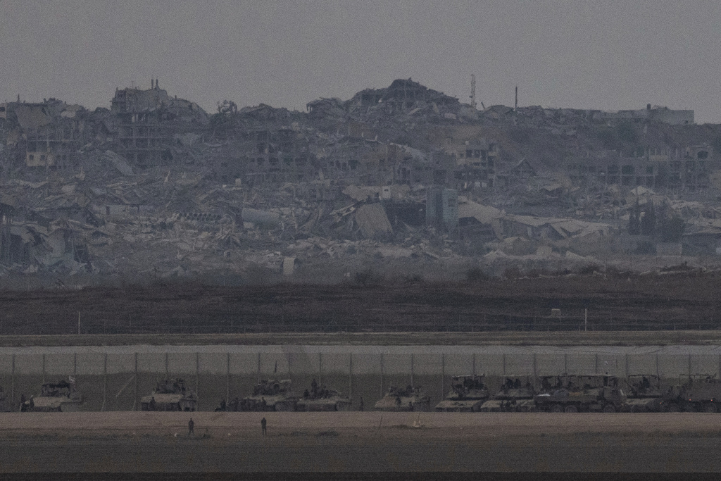 Israeli tanks and armored personnel carriers (APC) are parked at the Israeli-Gaza border, as seen from southern Israel, Thursday, Aug. 21, 2025. (AP Photo/Maya Levin)