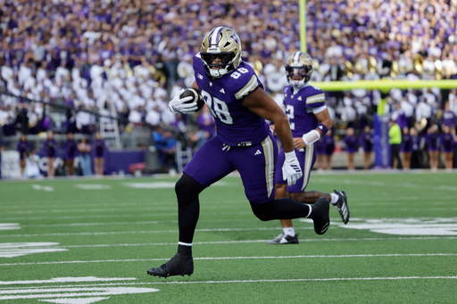 Washington tight end Quentin Moore (88) runs with the ball on a pass play against the Ohio State during the first half of an NCAA college football game, Saturday, Sept. 27, 2025, in Seattle. (AP Photo/John Froschauer) Washington tight end Quentin Moore (88) runs with the ball on a pass play against the Ohio State during the first half of an NCAA college football game, Saturday, Sept. 27, 2025, in Seattle. (AP Photo/John Froschauer)