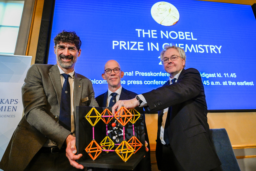From left, Chair of the Nobel Committee for Chemistry Heiner Linke, Secretary General of the Swedish Academy of Sciences Hans Ellegren, and Member of the Nobel Committee for Chemistry Olof Ramstrom pose after announcing Susumu Kitagawa, Richard Robson and Omar Yaghi as the recipients the Nobel Prize in Chemistry, at the Nobel Assembly of the Karolinska Institutet, in Stockholm, Sweden, Wednesday, Oct. 8, 2025. (Fredrik Sandberg/TT News Agency via AP)