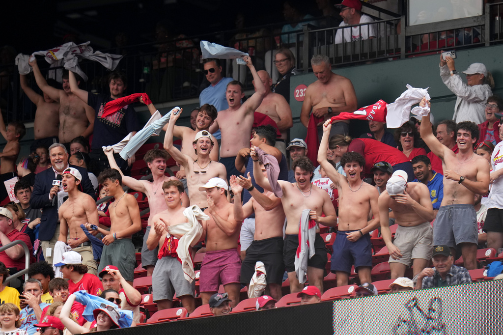Fans cheer and wave their shirts above their heads during the fourth inning of a baseball game between the St. Louis Cardinals and the Kansas City Royals Saturday, May 16, 2026, in St. Louis. (AP Photo/Jeff Roberson)
